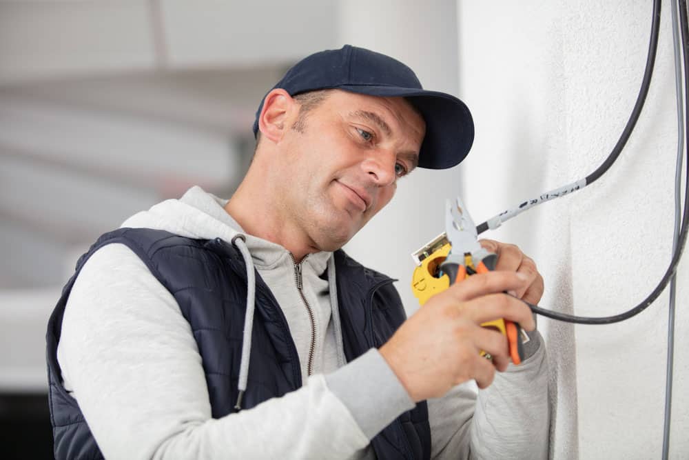 electrician examining current voltage with tools