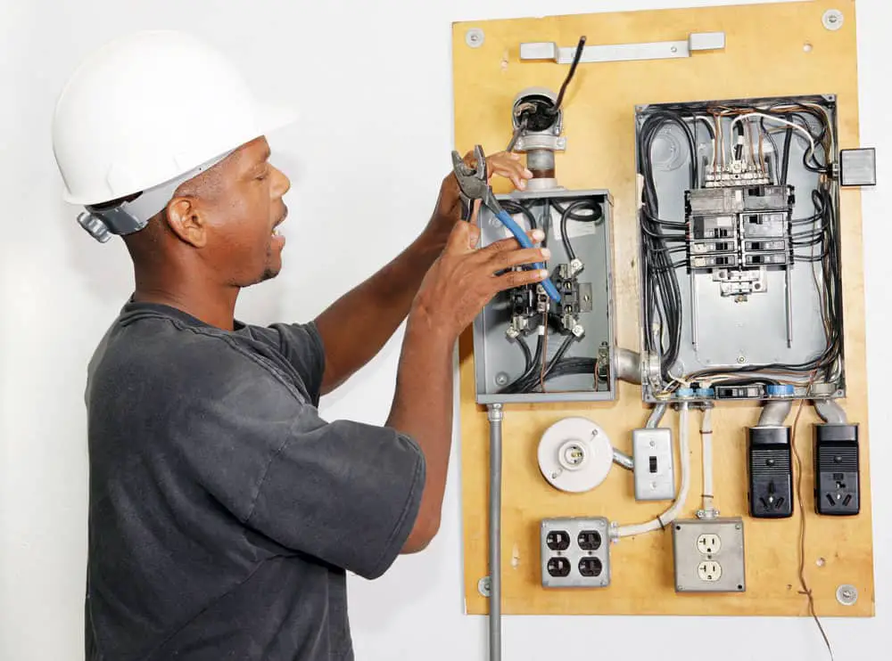 An electrician crimping the wire