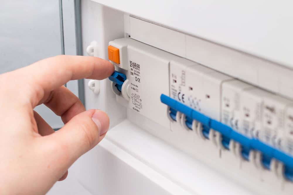 Man Turning off the fuse from a circuit board