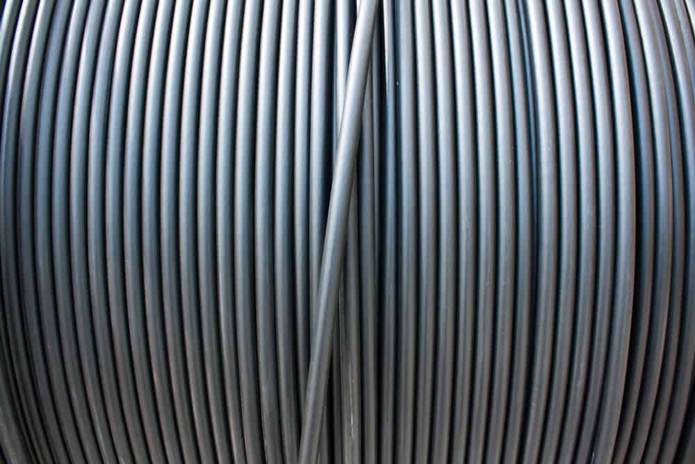 A close-up of black electricity cable on a spool