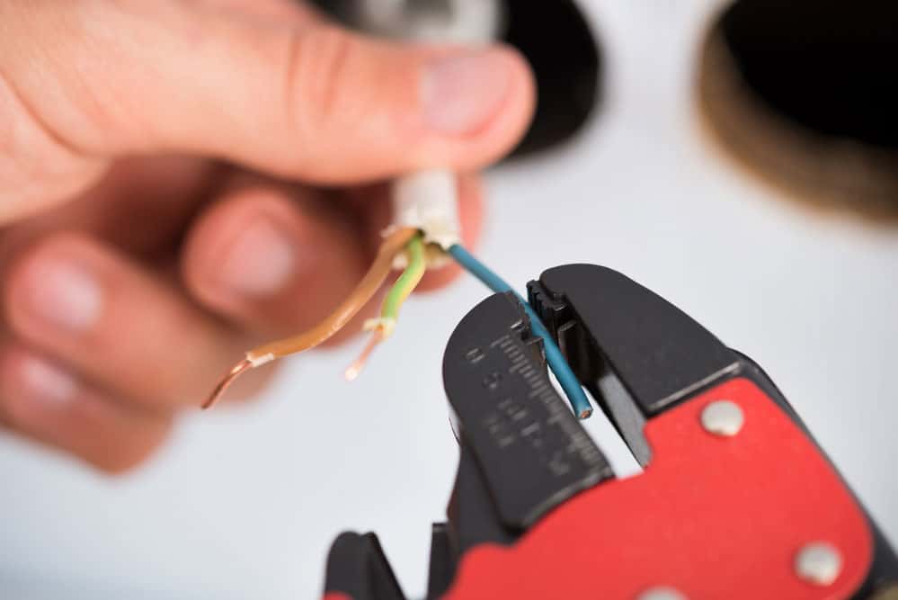 An electrician stripping a wire