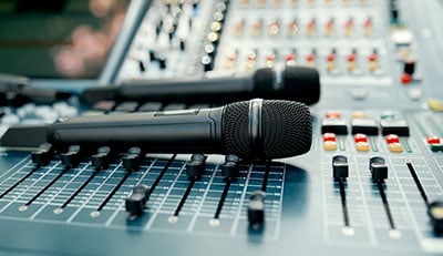 microphones on sound console before a performance