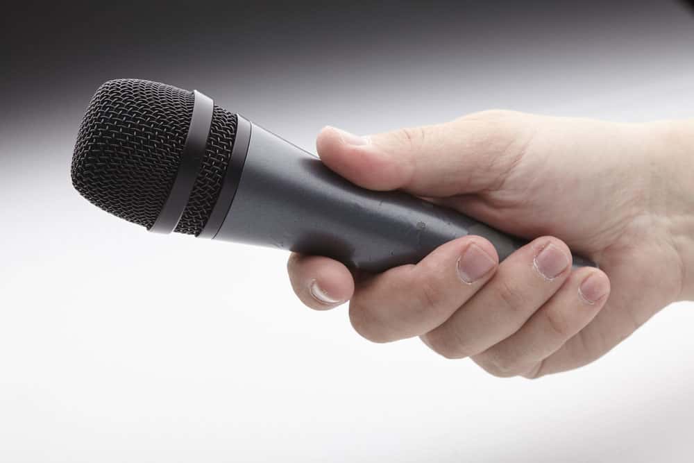 A wireless microphone in a man’s hand