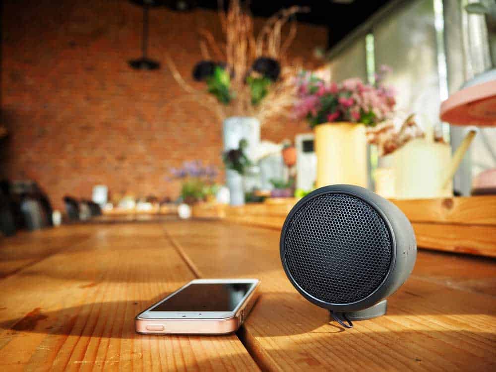 A phone connected to a Bluetooth speaker
