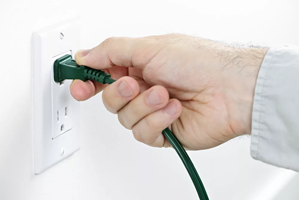 Removing the plug from an outlet