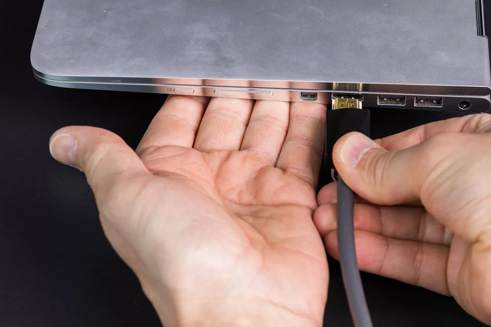 Connecting HDMI cable to the silver notebook