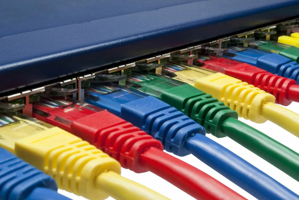 Rainbow color ethernet cables plugged into a router.