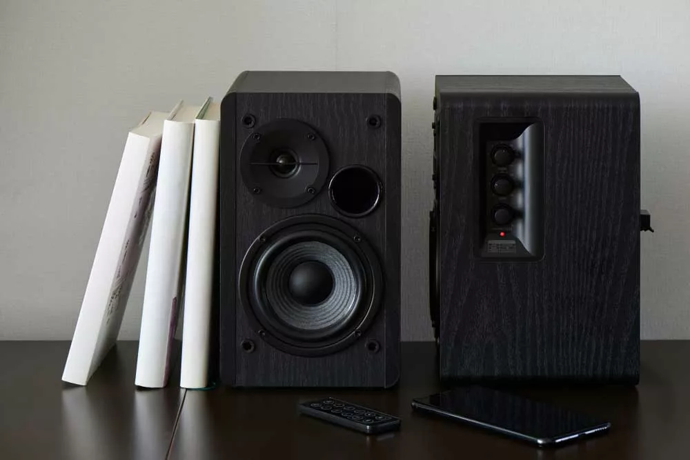 Bookshelf Speakers Near a Phone and Remote