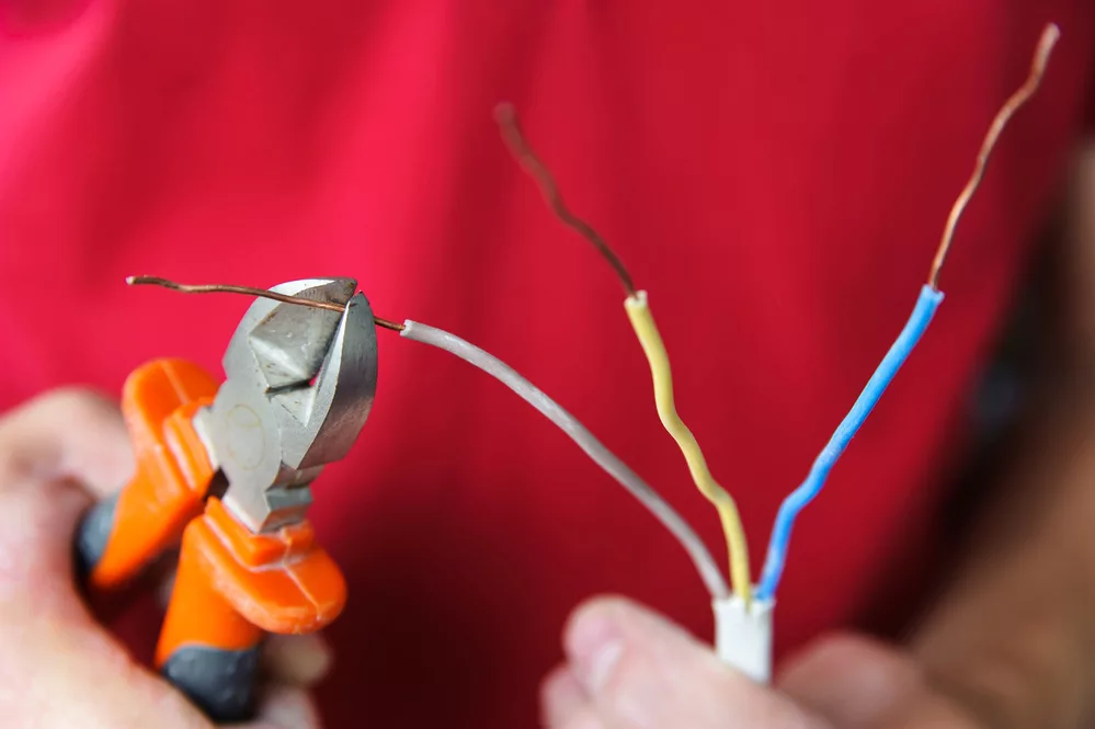 Electrician bending electric wires