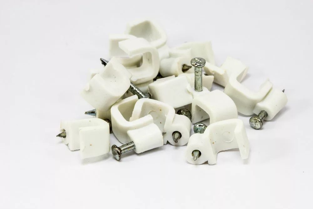 A pile of white cable clips