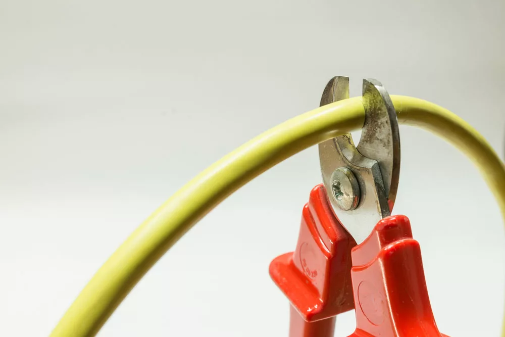 Pliers cutting an electrical cable