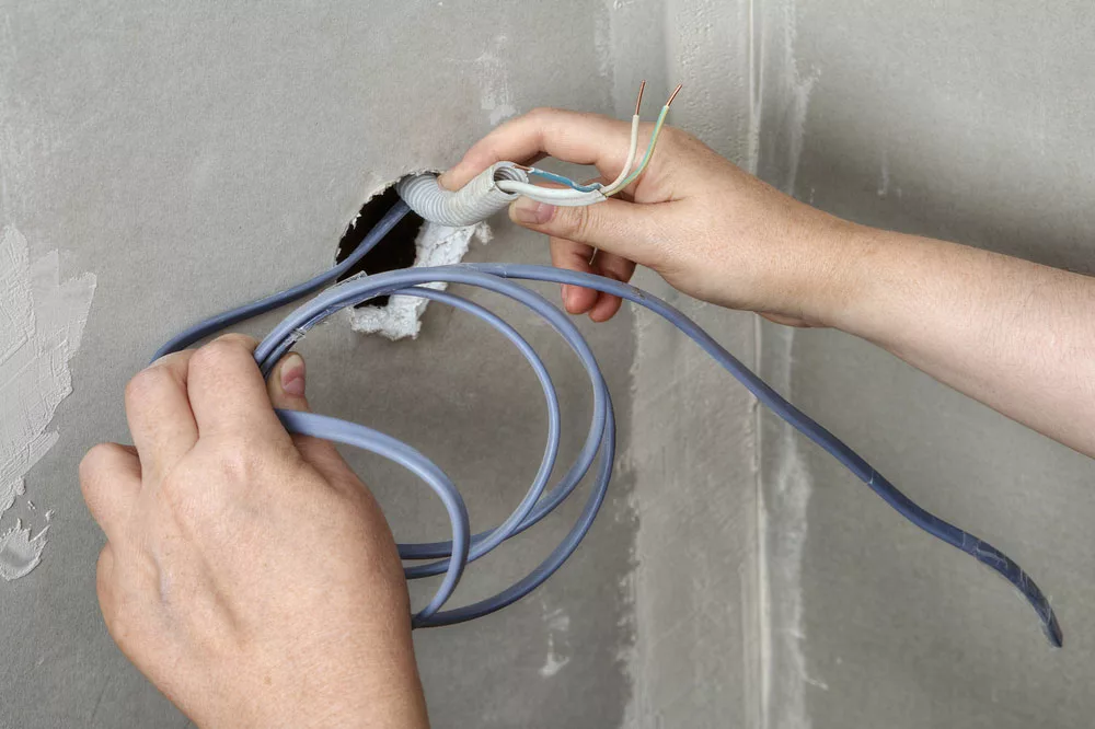 Pulling wires through a hole in a drywall
