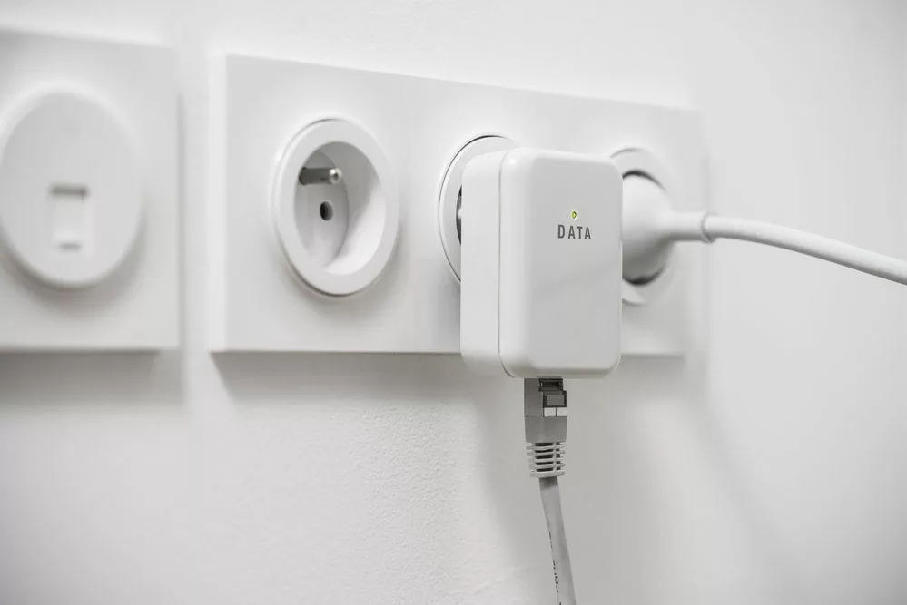 Caption: Powerline Adapter Connecting To Electrical Socket